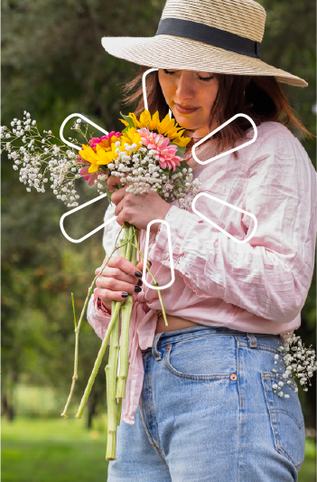 Persona sosteniendo ramo de flores en un campo